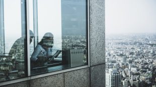 woman standing near window
