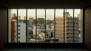 an empty room with a view of a city