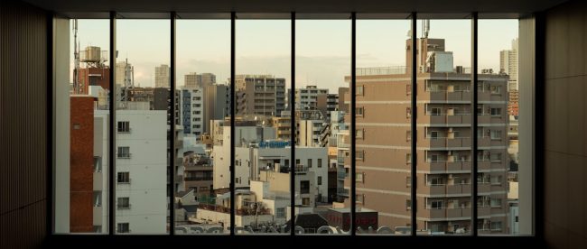 an empty room with a view of a city